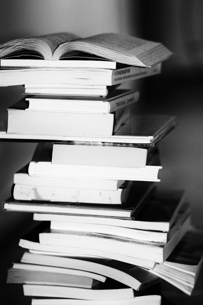 A monochrome image of a tall stack of books symbolizing education and knowledge.